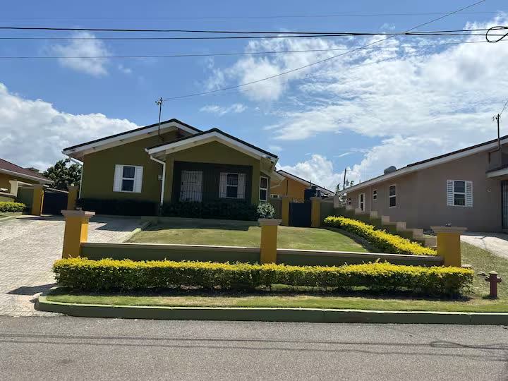 Street view of the house and hedged front garden