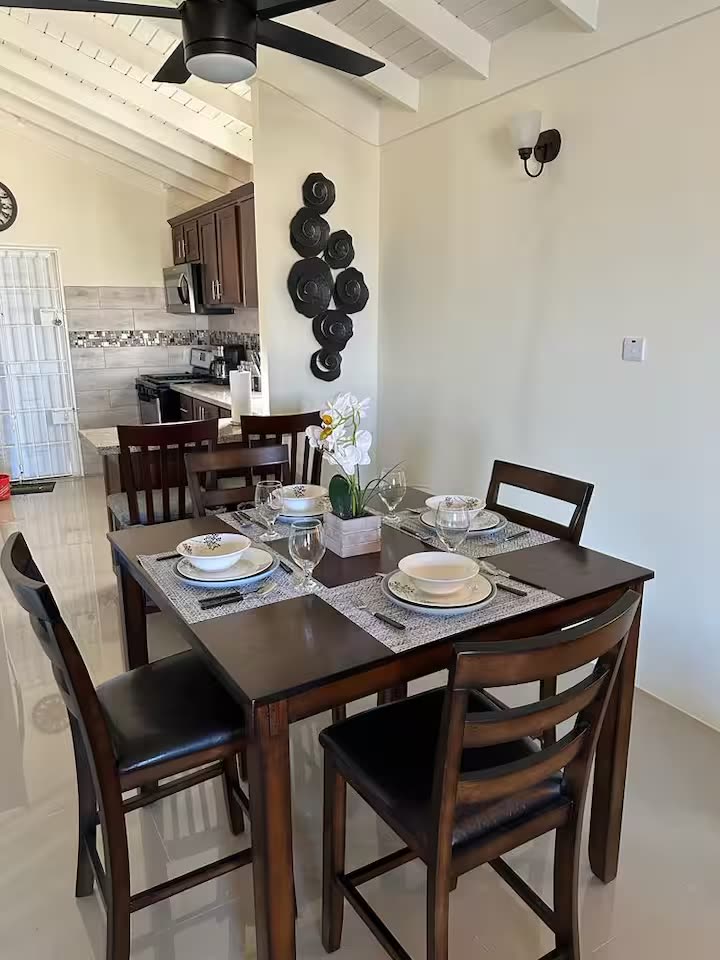 Dining table set for four beside the open kitchen