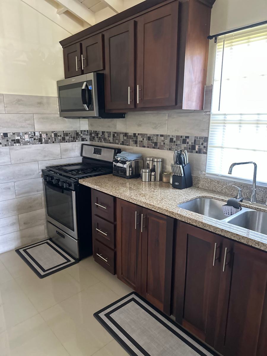 Kitchen with gas range, microwave and a window over the sink